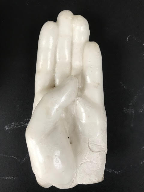 This mold still has the wax on it. The wax layer is very thin. A solid hand could not be extracted from the wax glove without damaging it.